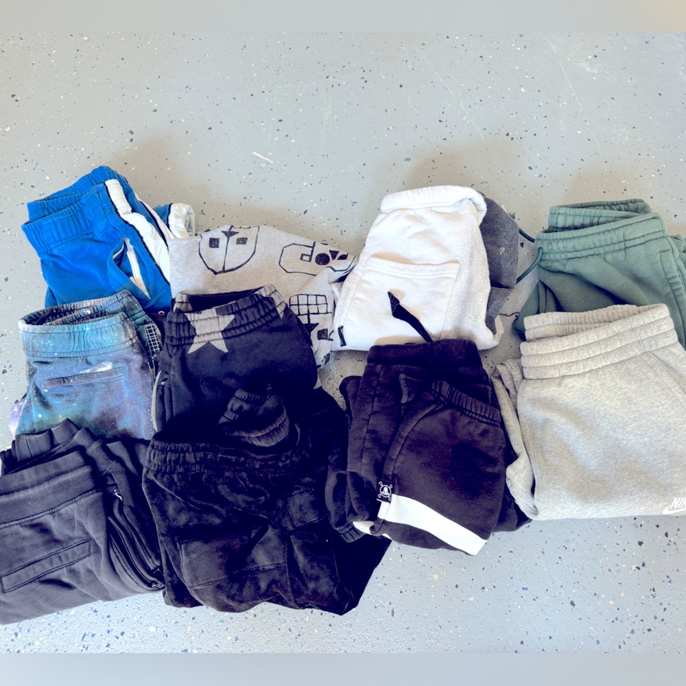 Bundle of kid (boy leaning) mostly European brand sweatpants.